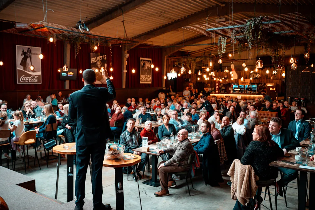 A speaker addressing a full room of sellers and managers at an OPTRIC sales event